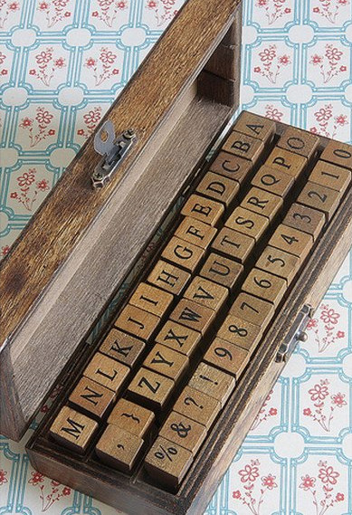 A wooden box of letter stamps