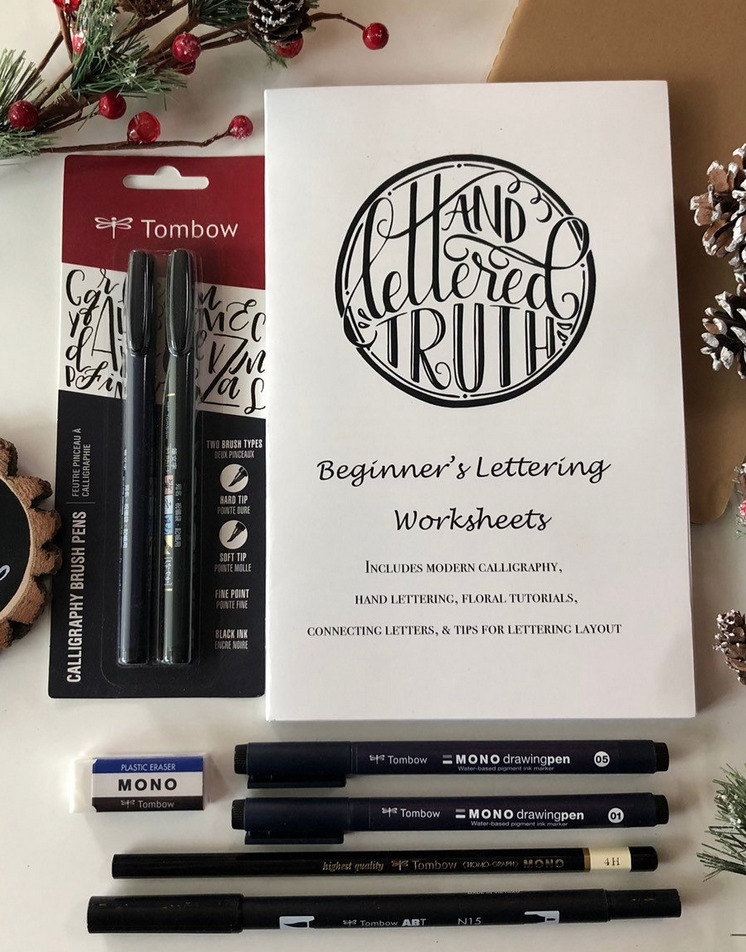 Handlettering kit including many brush pens, eraser, and a guide on how to do modern calligraphy with markers.