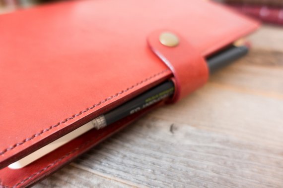 A red leather bullet journal cover.