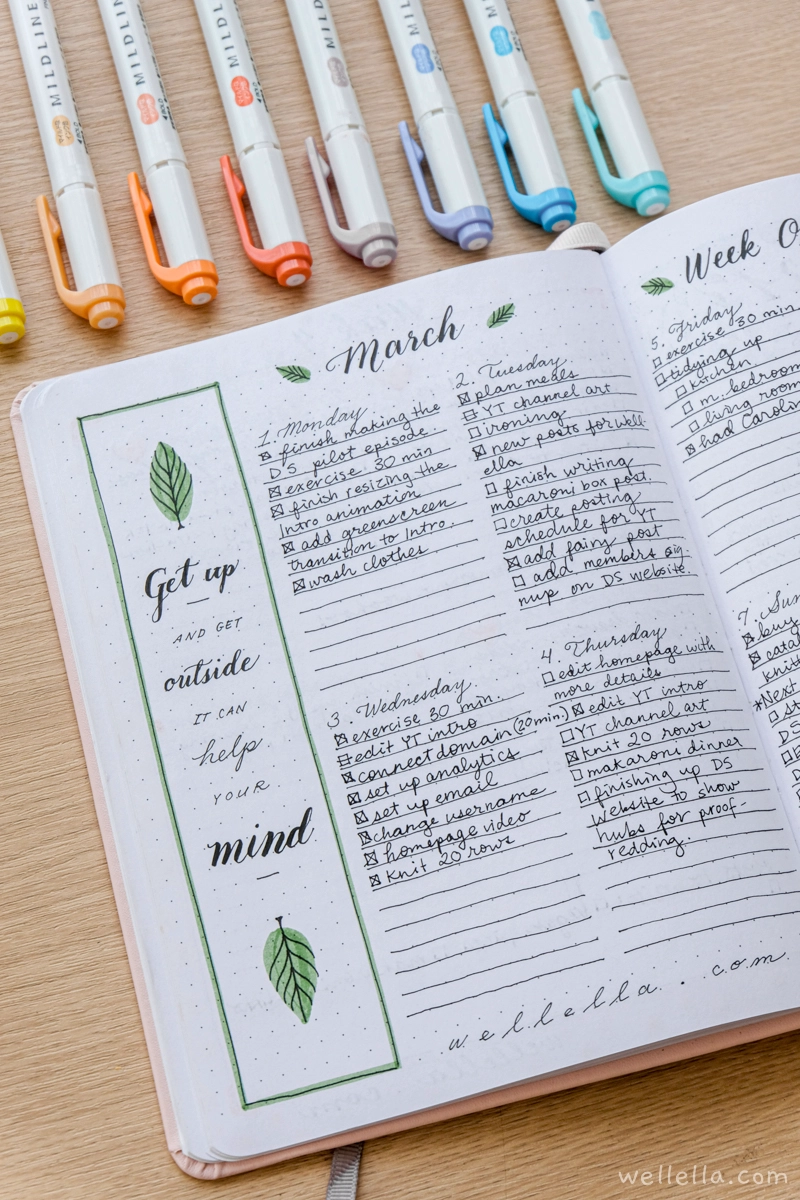 An open notebook on a table with colorful mildliner markers lined up next to it. On the notebook it says "March Week One" with notes for each day under headings of the days of the week.
