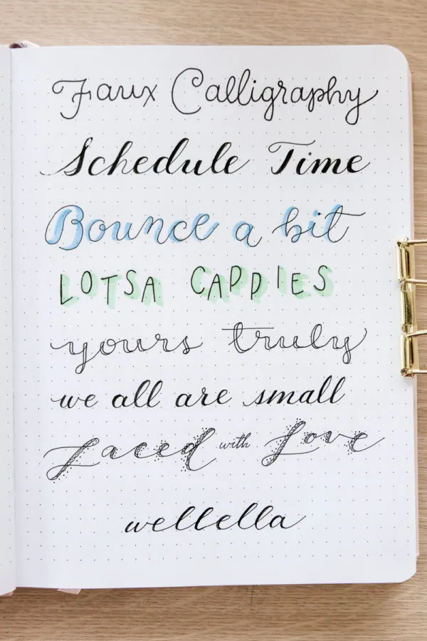 faux calligraphy examples of bullet journal fonts in a dot grid notebook.