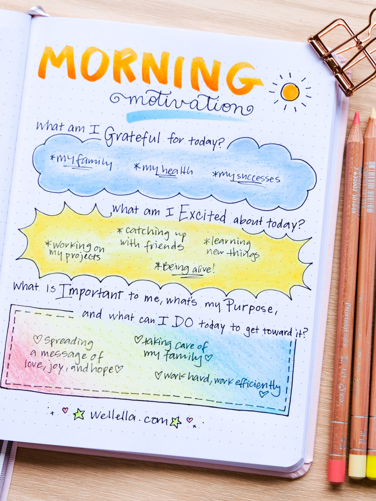 An open journal on a table with colored pencils beside it. On the page it says Morning Motivation with some journal prompts illustrated with colored pencil.